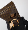 Louis Vuitton Monogram bag styled as a sculptural headpiece in a fashion editorial
