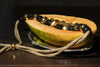 Gold and black vintage necklace displayed on a papaya from a Milanese private jewellery collection